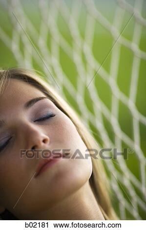 Close-up of a teenage girl resting on a hammock View Large Photo Image Stock Image - Close-up of a teenage girl resting on a hammock. Fotosearch