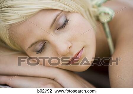 Stock Image - Close-up of a young woman with her eyes closed. Fotosearch