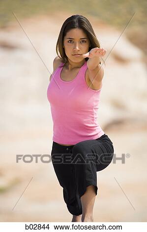 Picture - Portrait of a young woman exercising. Fotosearch