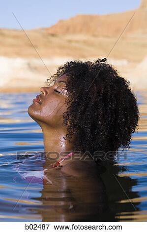 Profile of a young woman in a lake View Large Photo Image Stock Photo - Profile of a young woman in a lake. Fotosearch