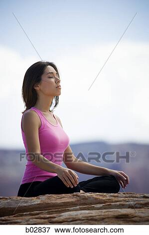 Profile of a young woman meditating View Large Photo Image Stock Photo - Profile of a young woman meditating. Fotosearch