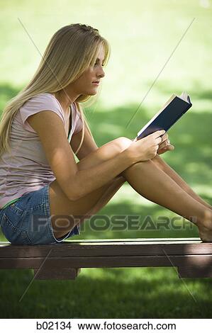 Picture - Profile of a young woman reading a book. Fotosearch