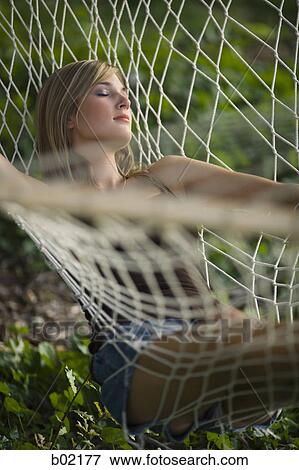 Teenage girl resting on a hammock View Large Photo Image Stock Photo - Teenage girl resting on a hammock. Fotosearch