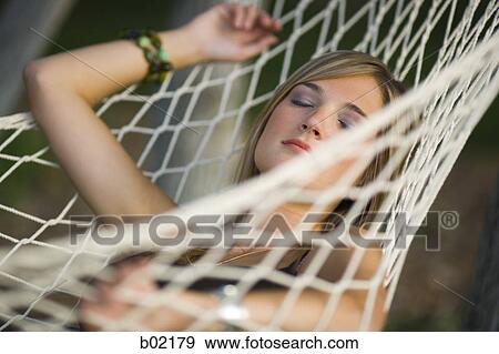 Stock Photo - Teenage girl resting on a hammock. Fotosearch