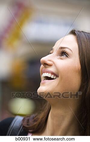 Close-up of a young woman looking up View Large Photo Image Stock Image - Close-up of a young woman looking up. Fotosearch