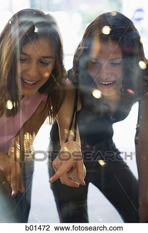 Two teenage girls window shopping View Large Photo Image Stock Image - Two teenage girls window shopping. Fotosearch