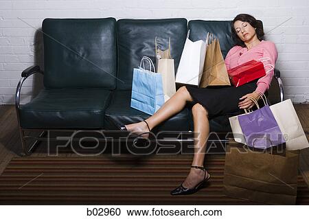 Woman asleep amidst a pile of shopping bags View Large Photo Image Stock Image - Woman asleep amidst a pile of shopping bags. Fotosearch