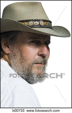 Stock Image - Close-up of a mature man wearing a cowboy hat. Fotosearch