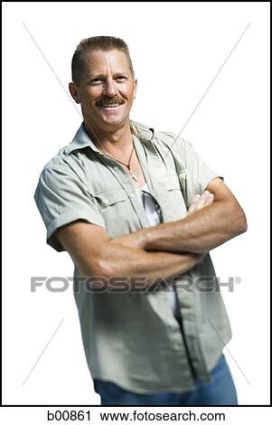 Portrait of a mature man standing with his arms crossed View Large Photo Image Stock Image - Portrait of a mature man standing with his arms crossed. Fotosearch