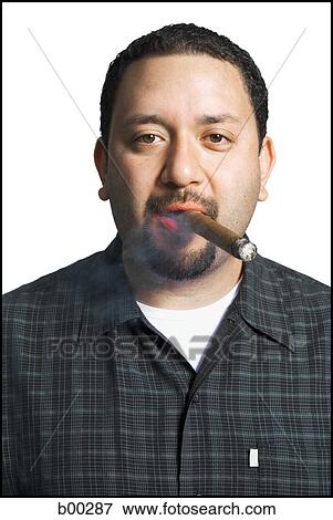 Portrait of a mid adult man smoking a cigar View Large Photo Image Stock Photo - Portrait of a mid adult man smoking a cigar. Fotosearch