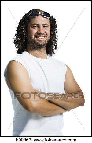 Portrait of an adult man standing with his arms crossed View Large Photo Image Stock Image - Portrait of an adult man standing with his arms crossed. Fotosearch