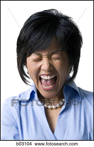 Close-up of a mid adult woman shouting with her eyes closed View Large Photo Image Picture - Close-up of a mid adult woman shouting with her eyes closed. Fotosearch