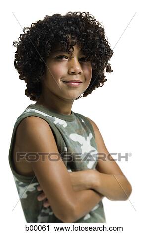 Stock Image - Portrait of a boy standing with her arms crossed. Fotosearch