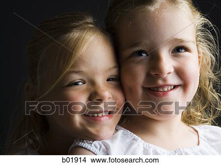 Close-up of two sisters smiling View Large Photo Image Picture - Close-up of two sisters smiling. Fotosearch