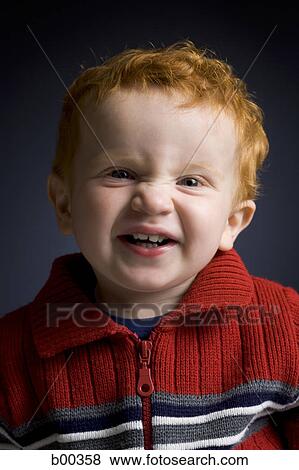 Stock Photo - Portrait of a baby boy making a face. Fotosearch