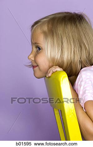 Portrait of a girl resting her head on a chair View Large Photo Image Stock Photography - Portrait of a girl resting her head on a chair. Fotosearch