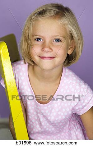 Portrait of a girl sitting on a chair View Large Photo Image Stock Photograph - Portrait of a girl sitting on a chair. Fotosearch
