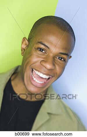 Portrait of a young man laughing View Large Photo Image Stock Photo - Portrait of a young man laughing. Fotosearch