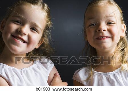 Stock Image - Portrait of two girls smiling. Fotosearch
