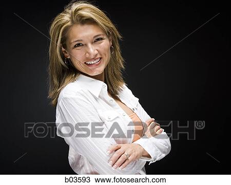 Young woman taking her top off View Large Photo Image Stock Image - Young woman taking her top off. Fotosearch