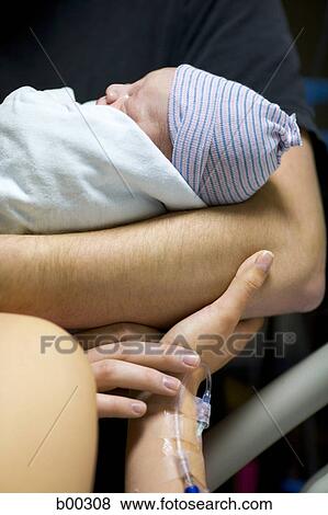 Close-up of a father carrying his newborn baby girl View Large Photo Image Stock Photo - Close-up of a father carrying his newborn baby girl. Fotosearch