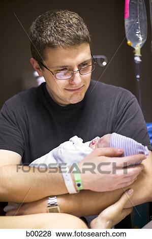 Stock Photo - Father carrying his newborn baby girl. Fotosearch