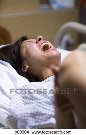 High angle view of a female patient showing uncomfortable expression View Large Photo Image Picture - High angle view of a female patient showing uncomfortable expression. Fotosearch