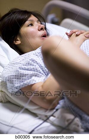 High angle view of a female patient lying on a bed View Large Photo Image Stock Photography - High angle view of a female patient lying on a bed. Fotosearch