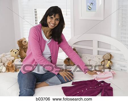 Stock Photograph - High angle view of a girl smiling in a park. Fotosearch
