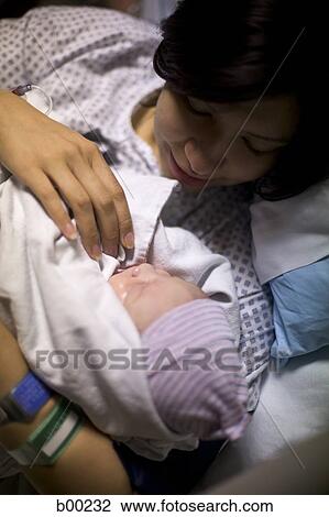 High angle view of a mother loving her newborn baby girl View Large Photo Image Stock Image - High angle view of a mother loving her newborn baby girl. Fotosearch