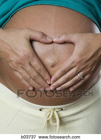 Portrait of a young woman standing with her hands on her hips View Large Photo Image Stock Photo - Portrait of a young woman standing with her hands on her hips. Fotosearch