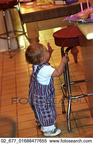 Baby, Home, Reaching, Inside, Toddler, Overalls, Stool View Large Photo Image Stock Photography - Baby, Home, Reaching, Inside, Toddler, Overalls, Stool. Fotosearch