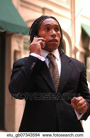 Picture - Business, Outside, Suit, African American, Cell Phone. Fotosearch