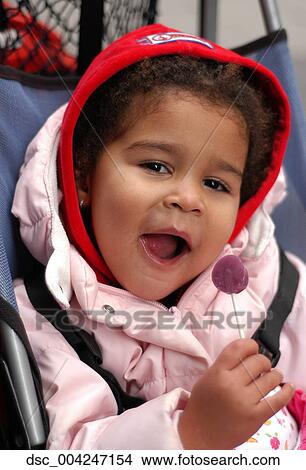 Child, Outside, Lollypop, Candy, African American, Jacket, Coat View Large Photo Image Picture - Child, Outside, Lollypop, Candy, African American, Jacket, Coat. Fotosearch