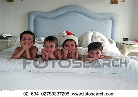 Christmas, Children, Boys, Girl, Santa Hat, Laying, Bed View Large Photo Image Stock Photography - Christmas, Children, Boys, Girl, Santa Hat, Laying, Bed. Fotosearch