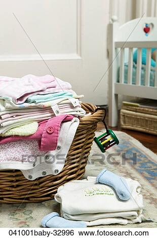 Stock Photograph - Clothes, Still Life, Clothing, Laundry, Baby, Basket, At Home. Fotosearch