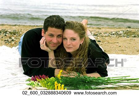 Couple, Beach, Sand, Blanket, Flowers View Large Photo Image Stock Photo - Couple, Beach, Sand, Blanket, Flowers. Fotosearch