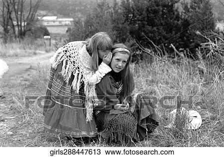 Stock Image - Outside, B/W, Girls, Secret, Telling, Whispering, Shawl. Fotosearch