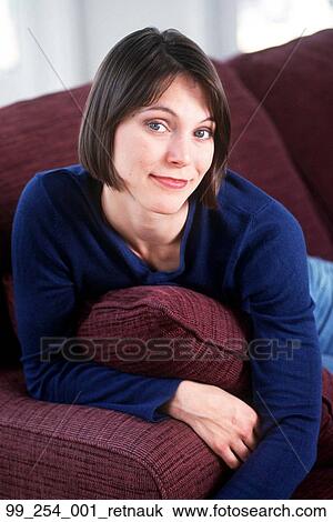 Sitting, Relaxing, Blue Shirt, Couch, Pillow View Large Photo Image Stock Image - Sitting, Relaxing, Blue Shirt, Couch, Pillow. Fotosearch