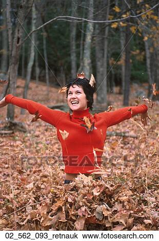 Stock Image - Woman, Happy, Autumn, Vitality, Laughing, Playing, Arms In Air. Fotosearch