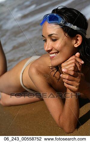 Stock Image - beach, beauty, bikini, dark, hair, nature, outside. Fotosearch