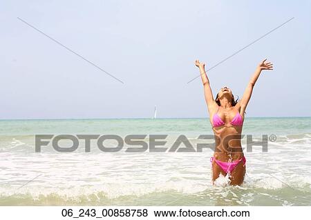 Stock Photo - beach, beauty, bikini, dark, hair, nature, outside. Fotosearch