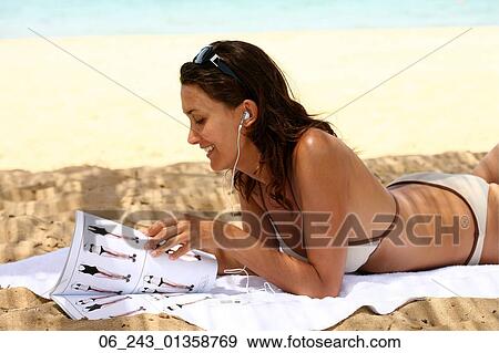 Stock Photo - beach, beauty, bikini, dark, hair, nature, outside. Fotosearch