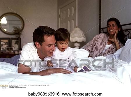 Stock Photograph - Bedroom, Father, Happy, Inside, Mother, Reading. Fotosearch