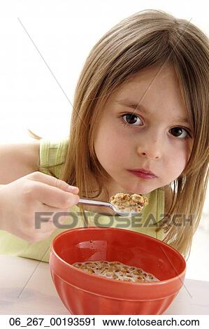 Stock Image - girl, eating, cereal. Fotosearch
