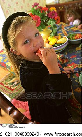 Stock Photo - Home, Eating, Holiday, Dinner, Table, Girl, Dress. Fotosearch