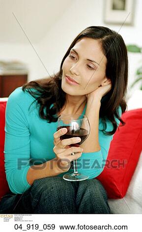 Stock Photo - Home, Woman, Inside, Relaxing, Smiling, Happy, alcohol. Fotosearch