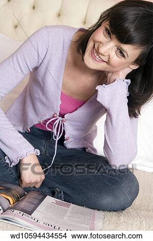 pink, camisole, blue, jeans, Sitting View Large Photo Image Picture - pink, camisole, blue, jeans, Sitting. Fotosearch