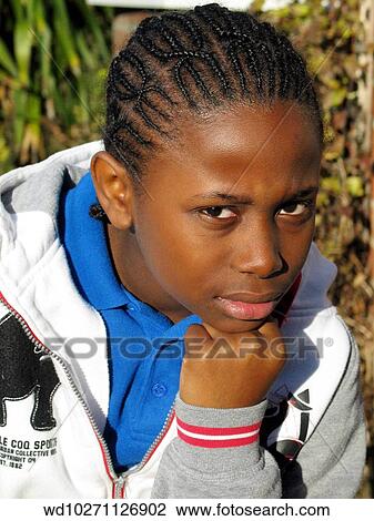 Stock Image - resting, chin, hand, looking. Fotosearch