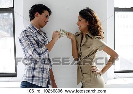 Stock Photograph - Smiling, Playful, Money, Laughing, Indoors, Finance. Fotosearch
